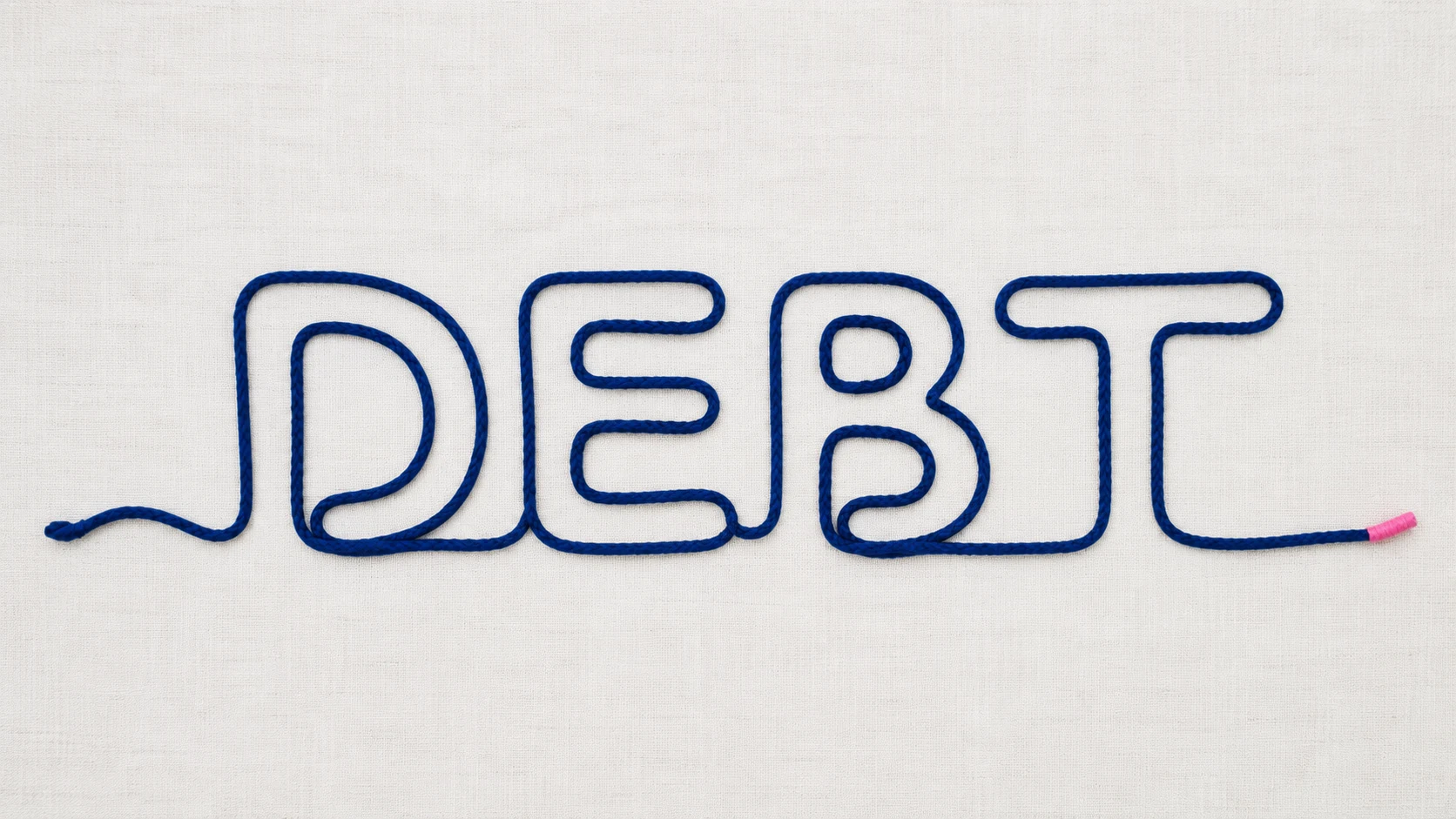 The word debt written in navy rope unraveling into a single straight line, symbolizing tax debt resolved