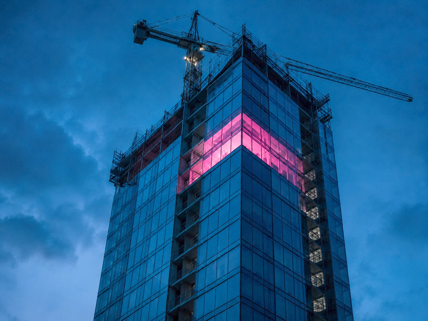 A glass tower lighting up floor by floor to a glowing summit, symbolizing a lasting wealth strategy